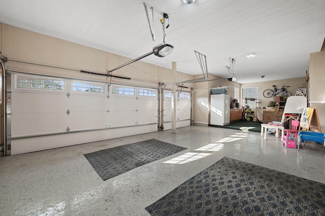 10008 Inshore Dr, Austin, TX 78730 - garage with freestanding refrigerator and a garage door opener