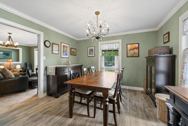 116 Ridgecrest Rd, Georgetown, TX 78628 - dining area featuring a chandelier, light wood-style flooring, and ornamental molding