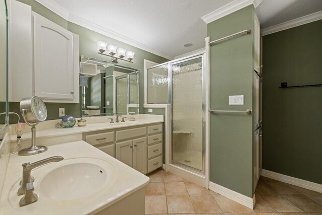 116 Ridgecrest Rd, Georgetown, TX 78628 - full bathroom featuring double vanity, a stall shower, crown molding, and tile patterned floors