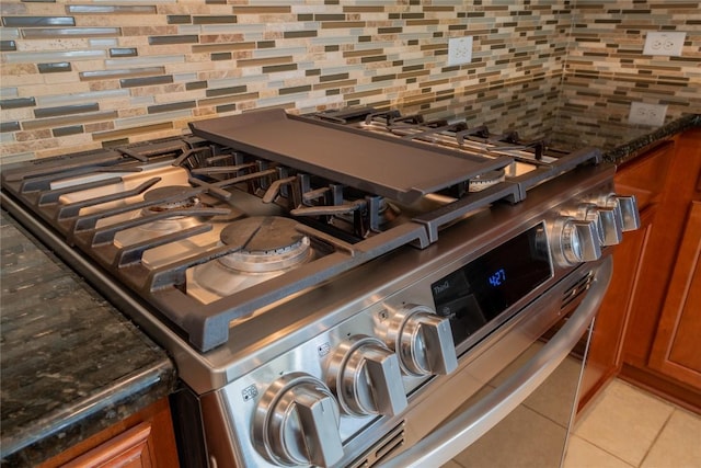 11612 Yeadon Way, Austin, TX 78717 - kitchen view of tasteful backsplash, stainless steel gas stove, and brown cabinets