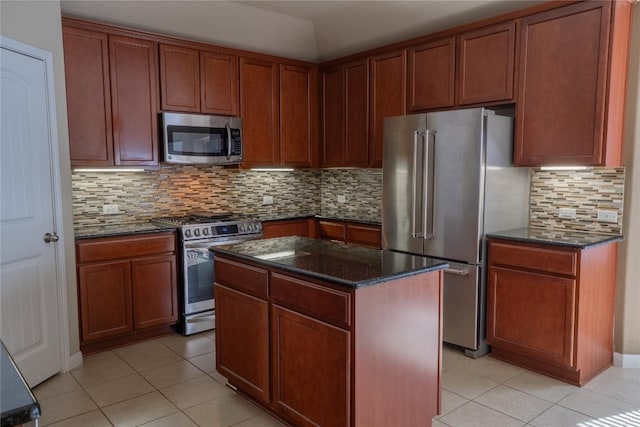 11612 Yeadon Way, Austin, TX 78717 - kitchen featuring stainless steel appliances, light tile patterned flooring, dark stone counters, and decorative backsplash