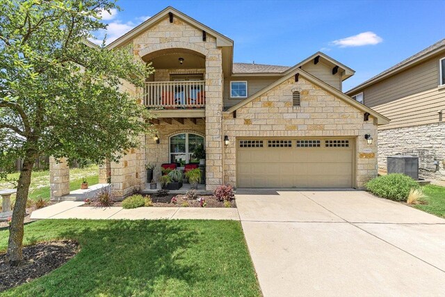 11600 Santa Elena Ln, Austin, TX 78717 - view of front facade featuring a balcony, stone siding, driveway, a garage, and a front lawn
