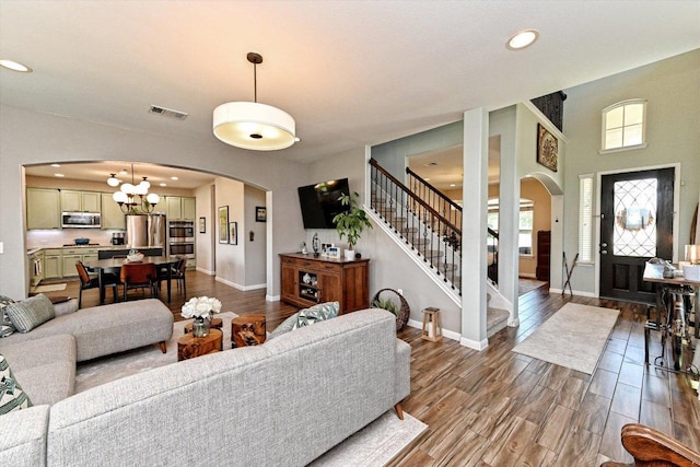 11600 Santa Elena Ln, Austin, TX 78717 - living area with arched walkways, a chandelier, stairway, recessed lighting, and wood finished floors