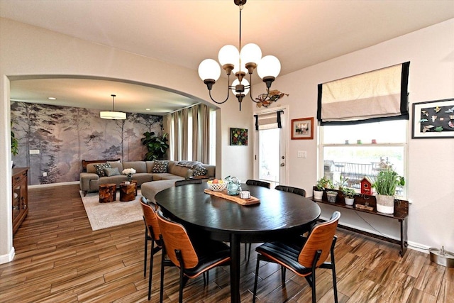 11600 Santa Elena Ln, Austin, TX 78717 - dining space featuring arched walkways, wood finished floors, and a chandelier