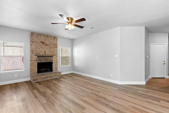 1207 York Castle Dr, Pflugerville, TX 78660 - unfurnished living room with ceiling fan, wood finished floors, and a fireplace