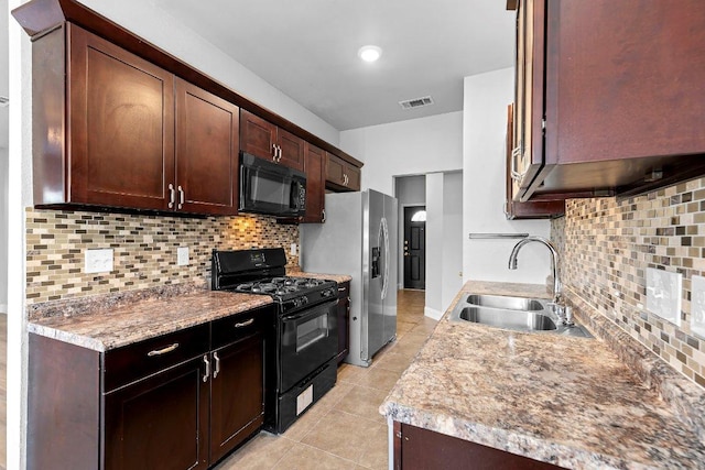 1207 York Castle Dr, Pflugerville, TX 78660 - kitchen with black appliances, light tile patterned floors, backsplash, dark brown cabinets, and light countertops
