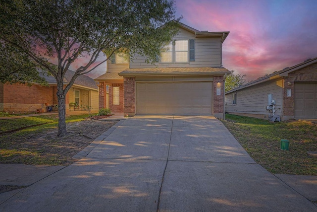 132 Hillhouse Ln, Manchaca, TX 78652 - view of front of house featuring a garage, driveway, and brick siding