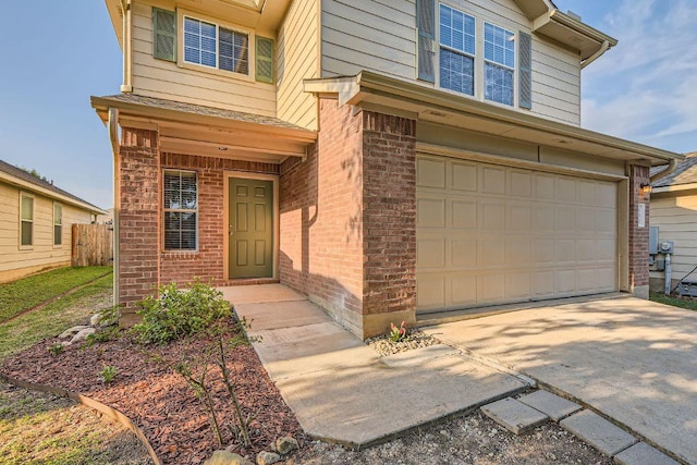 132 Hillhouse Ln, Manchaca, TX 78652 - property entrance featuring brick siding, an attached garage, and concrete driveway