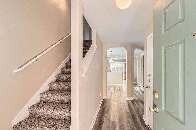 132 Hillhouse Ln, Manchaca, TX 78652 - foyer featuring arched walkways, dark wood-style flooring, and stairway