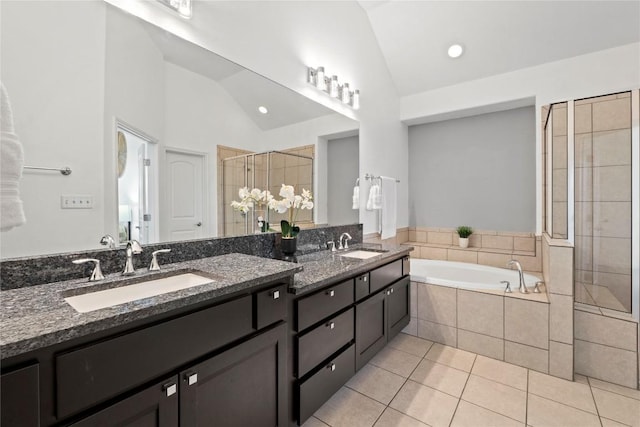 12221 Fairway Cv, Austin, TX 78732 - bathroom with vaulted ceiling, double vanity, a bath, tile patterned flooring, and a shower stall