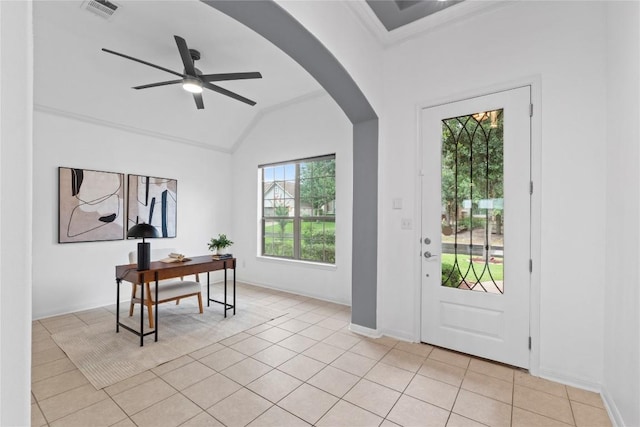 12221 Fairway Cv, Austin, TX 78732 - foyer entrance with vaulted ceiling, ceiling fan, light tile patterned flooring, crown molding, and arched walkways