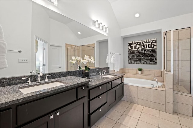 12221 Fairway Cv, Austin, TX 78732 - full bathroom with vaulted ceiling, double vanity, a garden tub, tile patterned floors, and a stall shower