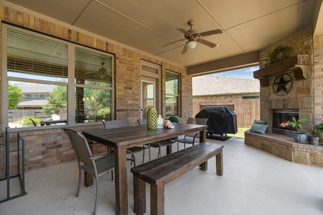 139 Merion Dr, Austin, TX 78737 - view of patio featuring an outdoor stone fireplace, a grill, a ceiling fan, and outdoor dining area