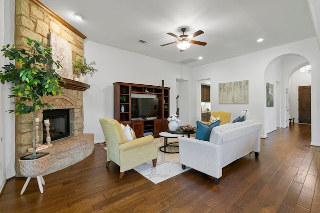 139 Merion Dr, Austin, TX 78737 - living area featuring ceiling fan, dark wood finished floors, arched walkways, a stone fireplace, and recessed lighting