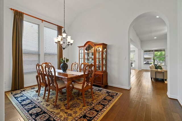 139 Merion Dr, Austin, TX 78737 - dining space featuring arched walkways, hardwood / wood-style floors, a chandelier, vaulted ceiling, and recessed lighting