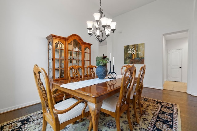 139 Merion Dr, Austin, TX 78737 - dining room featuring a chandelier, hardwood / wood-style flooring, and a towering ceiling