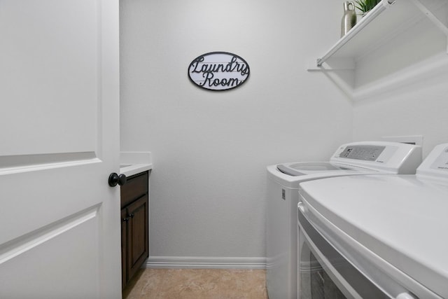 139 Merion Dr, Austin, TX 78737 - laundry area with washing machine and clothes dryer and cabinet space