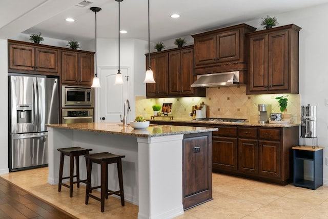 139 Merion Dr, Austin, TX 78737 - kitchen with stainless steel appliances, ventilation hood, stone countertops, tasteful backsplash, and dark brown cabinets