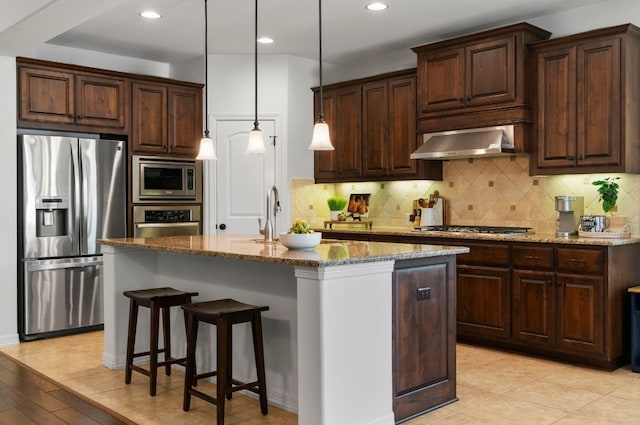 139 Merion Dr, Austin, TX 78737 - kitchen featuring stainless steel appliances, range hood, stone countertops, a center island with sink, and recessed lighting