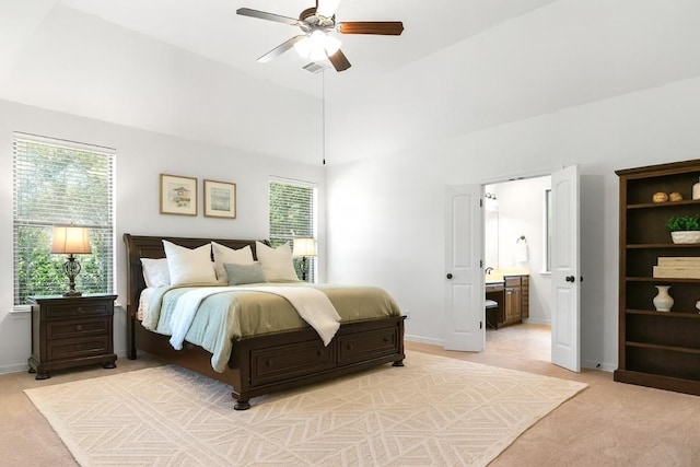 139 Merion Dr, Austin, TX 78737 - bedroom with multiple windows, light colored carpet, ensuite bathroom, a towering ceiling, and a ceiling fan