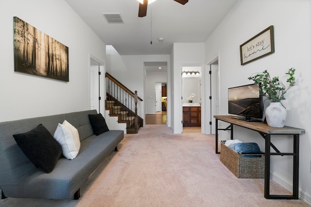 139 Merion Dr, Austin, TX 78737 - living room featuring stairway, light colored carpet, and ceiling fan