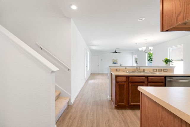 1431 Davis Mountain Loop, Cedar Park, TX 78613 - kitchen featuring stainless steel dishwasher, light wood finished floors, light countertops, a chandelier, and brown cabinetry