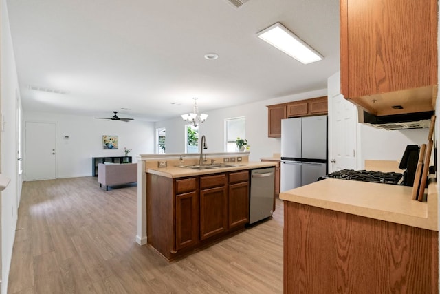 1431 Davis Mountain Loop, Cedar Park, TX 78613 - kitchen with dishwasher, freestanding refrigerator, light countertops, and light wood-type flooring