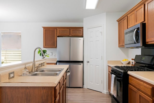 1431 Davis Mountain Loop, Cedar Park, TX 78613 - kitchen featuring stainless steel appliances, light wood-type flooring, light countertops, and brown cabinetry