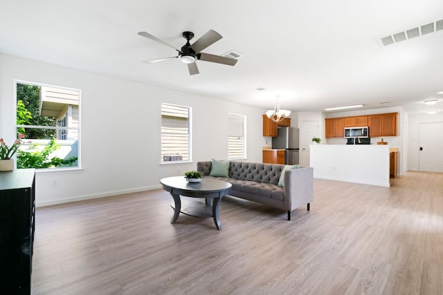 1431 Davis Mountain Loop, Cedar Park, TX 78613 - living room with a chandelier, healthy amount of natural light, light wood finished floors, and a ceiling fan