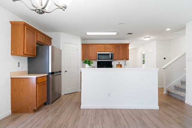 1431 Davis Mountain Loop, Cedar Park, TX 78613 - kitchen featuring stainless steel appliances, light wood-type flooring, light countertops, brown cabinetry, and recessed lighting