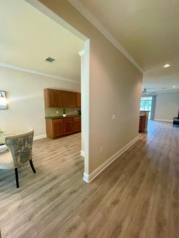209 Crockett Loop, Georgetown, TX 78633 - hall with ornamental molding, light wood finished floors, and recessed lighting