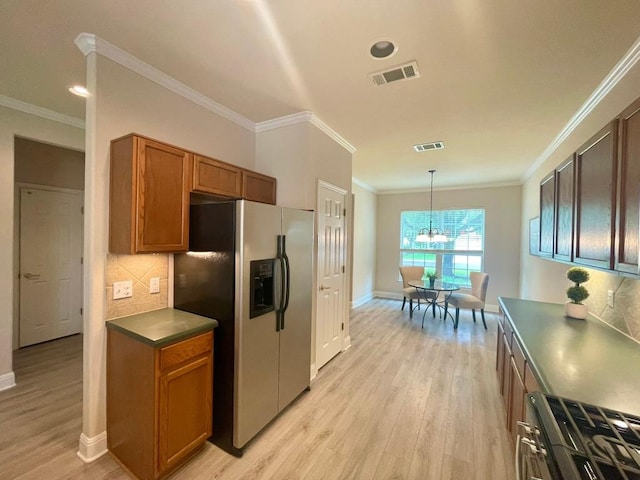 209 Crockett Loop, Georgetown, TX 78633 - kitchen featuring stainless steel refrigerator with ice dispenser, black gas range, light wood finished floors, a chandelier, and brown cabinetry