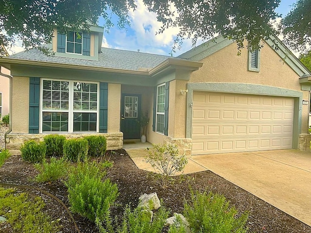 209 Crockett Loop, Georgetown, TX 78633 - view of front of property with stucco siding, a garage, driveway, stone siding, and a shingled roof