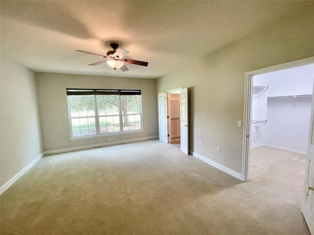 209 Crockett Loop, Georgetown, TX 78633 - unfurnished bedroom with light colored carpet, a spacious closet, and ceiling fan