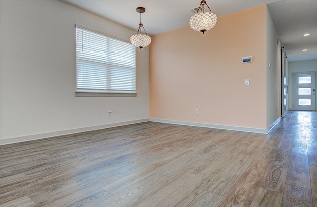 228 Tequilana Pass, Leander, TX 78641 - unfurnished room with light wood-style flooring and a barn door