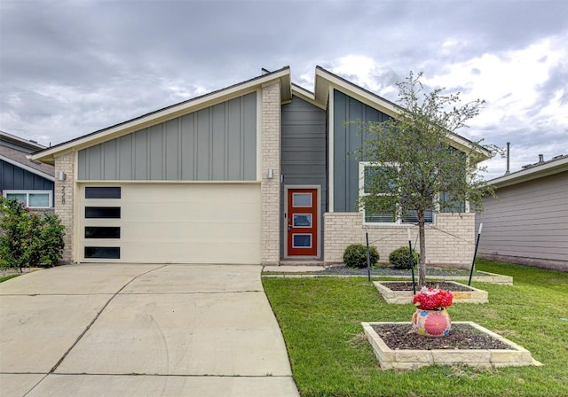 228 Tequilana Pass, Leander, TX 78641 - view of front of property with board and batten siding, a front yard, driveway, a garage, and brick siding