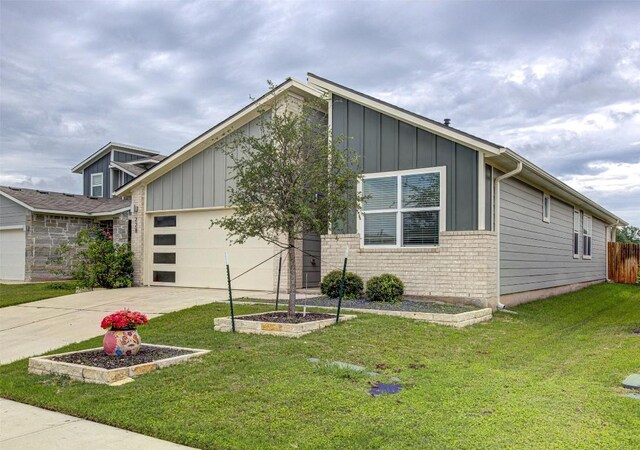 228 Tequilana Pass, Leander, TX 78641 - view of front of home with board and batten siding, a garage, driveway, and brick siding