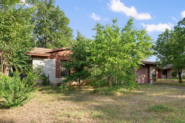 2329 Campden Dr, Austin, TX 78745 - view of green lawn with a garage