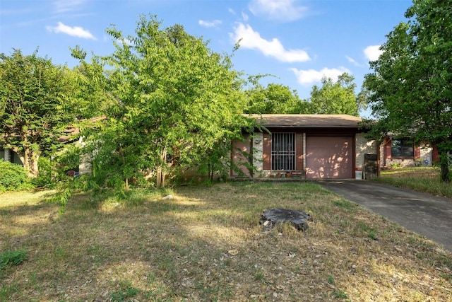 2329 Campden Dr, Austin, TX 78745 - view of yard featuring asphalt driveway and a garage