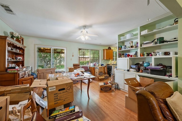 2329 Campden Dr, Austin, TX 78745 - home office featuring light wood finished floors, a ceiling fan, and crown molding
