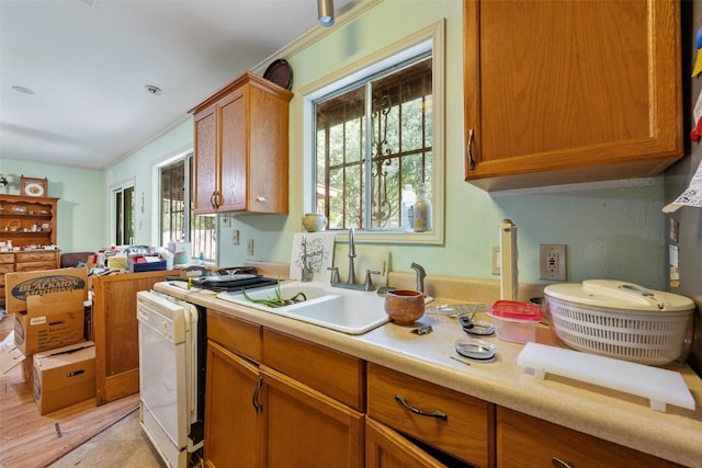 2329 Campden Dr, Austin, TX 78745 - kitchen with dishwashing machine, light countertops, brown cabinets, and light wood-type flooring
