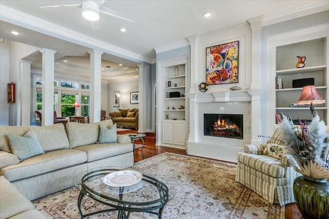 1208 Verdant Way, Austin, TX 78746 - living area featuring ornate columns, ceiling fan, wood finished floors, ornamental molding, and a premium fireplace