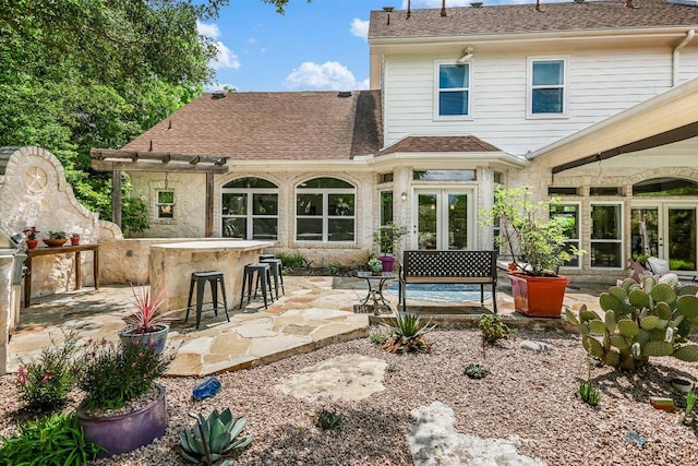 1208 Verdant Way, Austin, TX 78746 - back of property featuring a patio area, roof with shingles, a pergola, and french doors