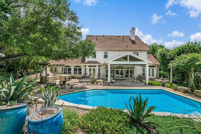 1208 Verdant Way, Austin, TX 78746 - outdoor pool with french doors and a patio area