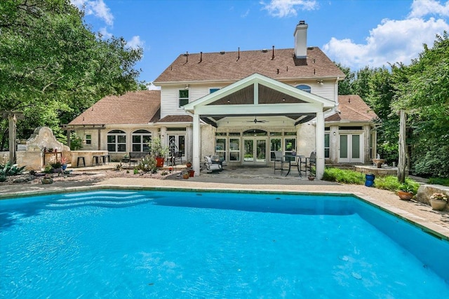 1208 Verdant Way, Austin, TX 78746 - back of property featuring french doors, a patio, a ceiling fan, and a chimney