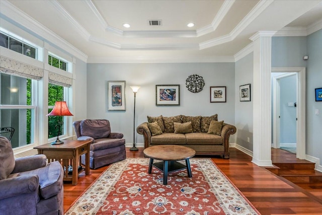 1208 Verdant Way, Austin, TX 78746 - living room featuring ornate columns, wood finished floors, a raised ceiling, and ornamental molding