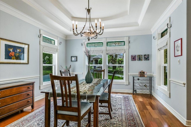 1208 Verdant Way, Austin, TX 78746 - dining space with a chandelier, wood finished floors, crown molding, and a raised ceiling