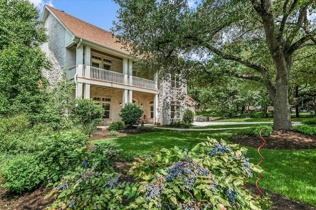 1208 Verdant Way, Austin, TX 78746 - back of house with a balcony, a yard, and stucco siding