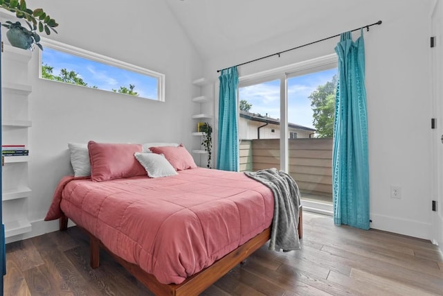 5006 Lott Ave Unit 2, Austin, TX 78721 - bedroom featuring access to exterior, vaulted ceiling, multiple windows, and wood finished floors