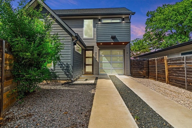5006 Lott Ave Unit 2, Austin, TX 78721 - rear view of property with driveway, a fenced backyard, and an attached garage